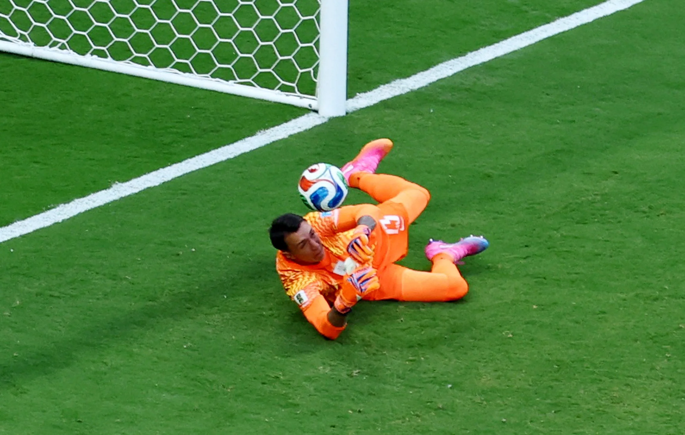 Spain's Alex Baena scores their first goal past Uruguay's Fernando Muslera