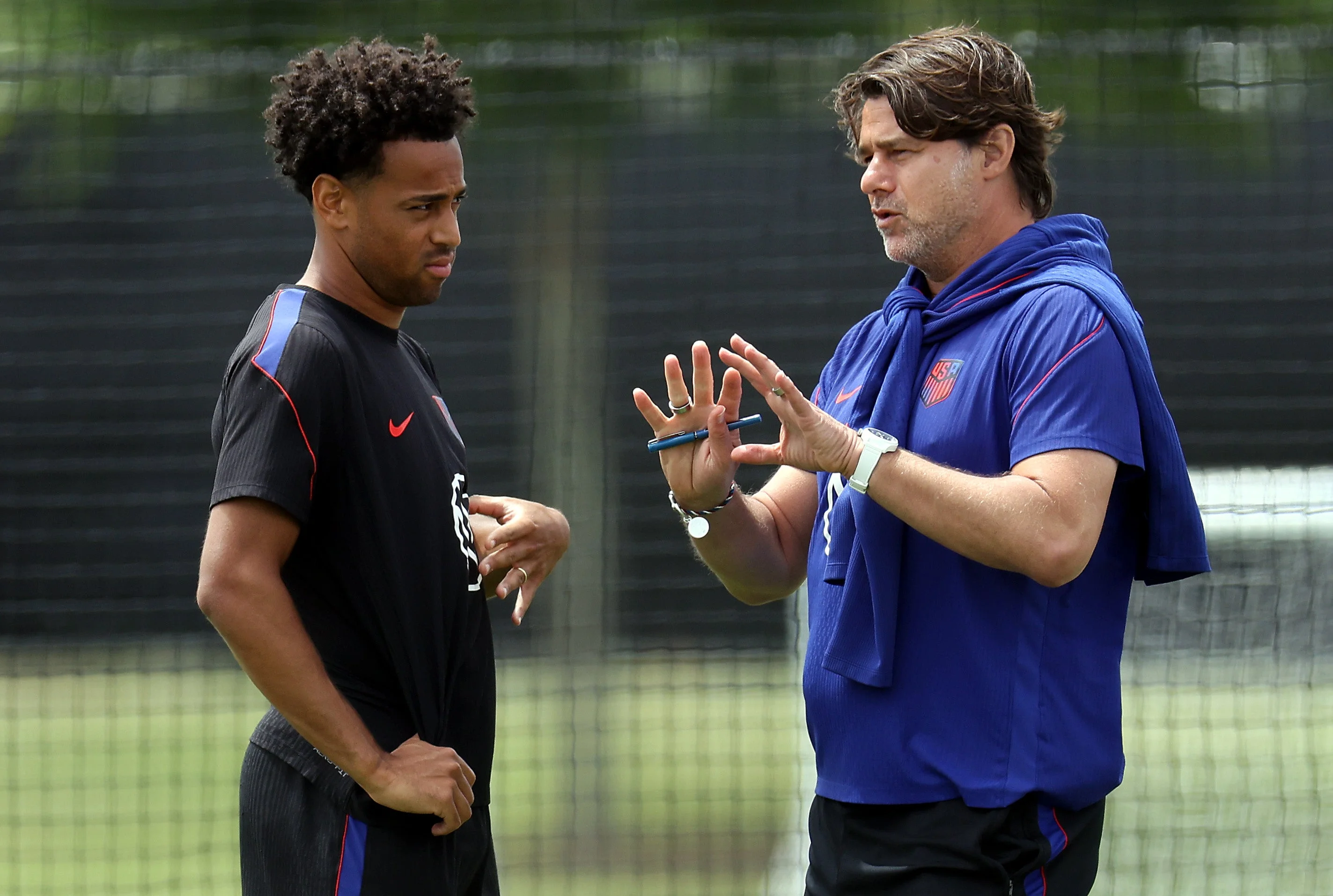 Head coach Mauricio Pochettino of the United States talks with Tyler Adams during a training session