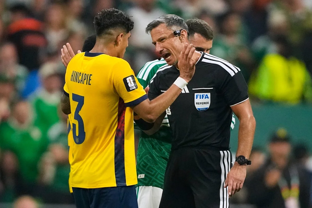 Why are red cards given to World Cup players covering their mouths?